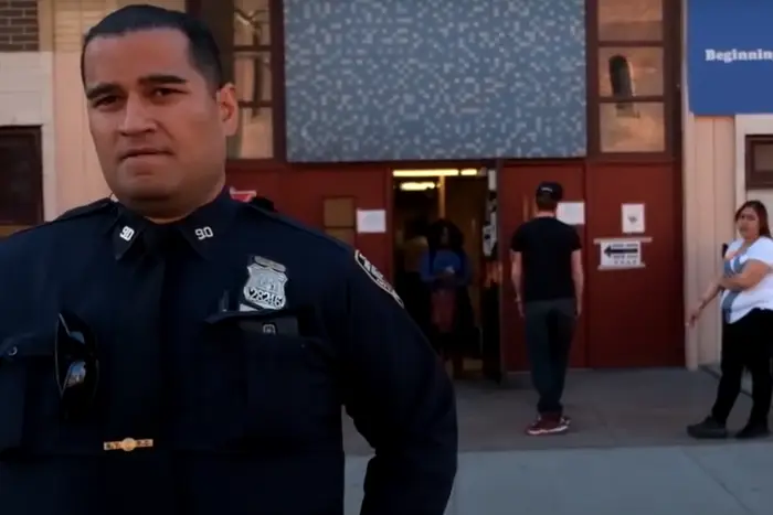 A police officer stands in front of a Brooklyn Polling site